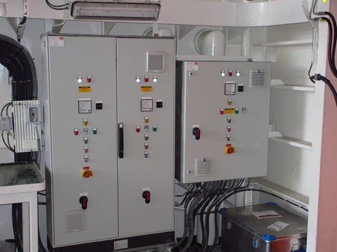 A pair of control panels with meters, indicators and selector switches