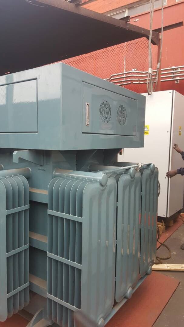 An oil-filled distribution transformer with its cooling radiators