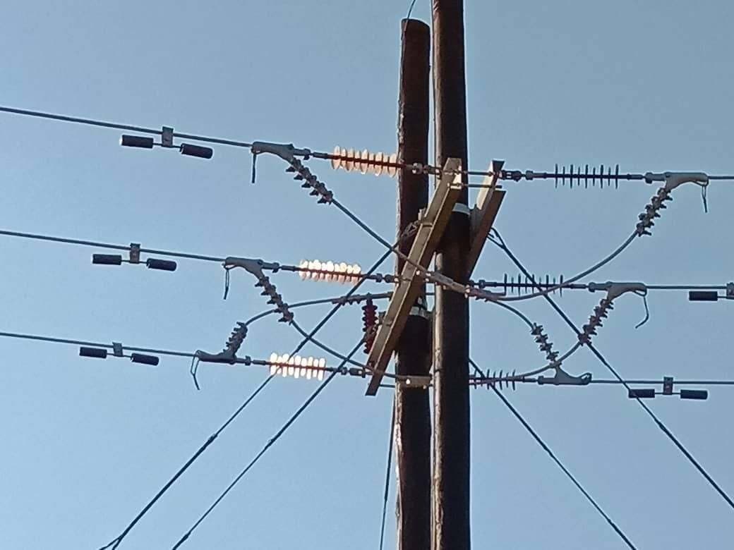 Overhead line conductors and insulators on a pole crossarm