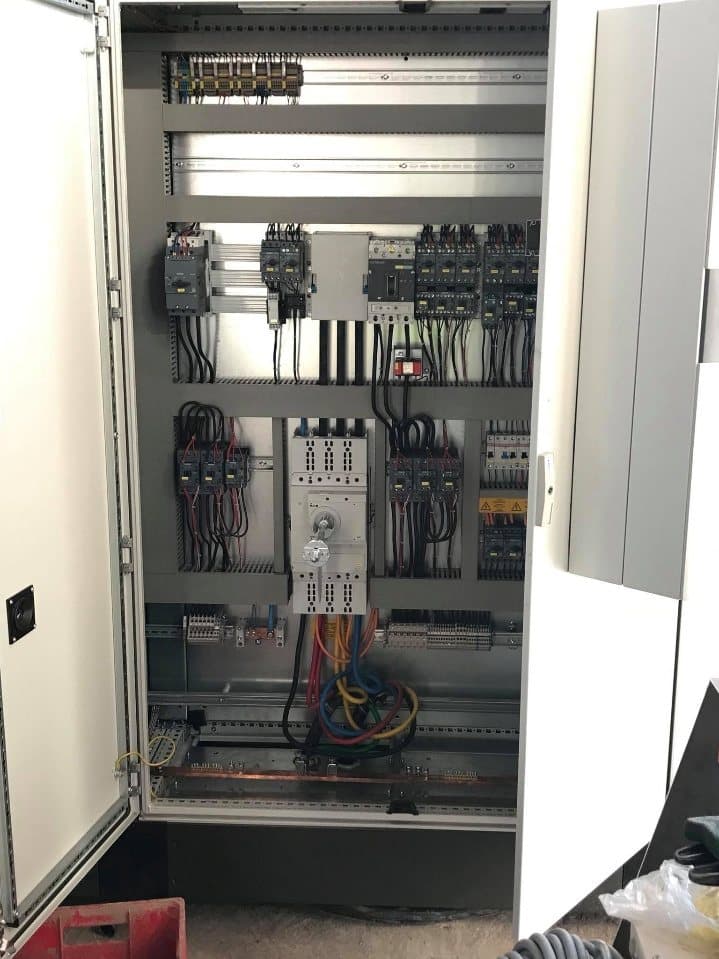 The interior of a control panel with its door open during wiring