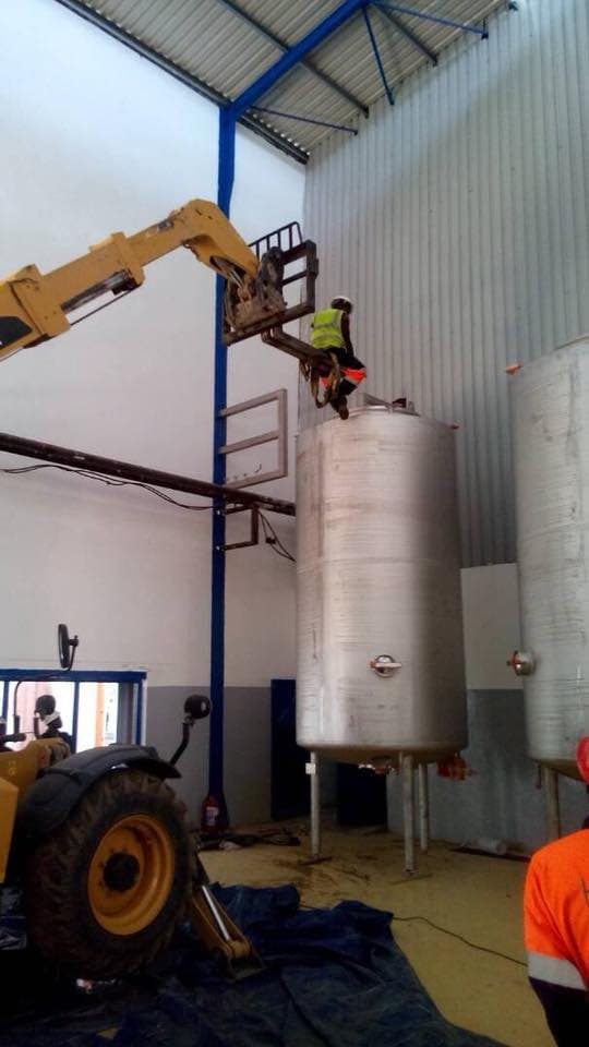 Vessels being set in place in a plant building with a crane