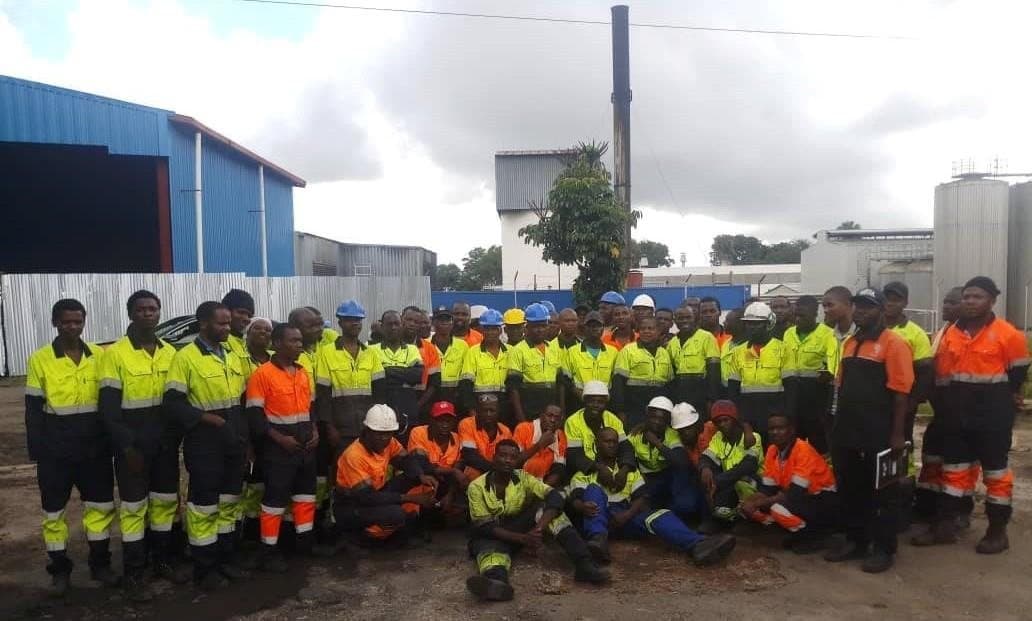 The site team assembled in full PPE outside the plant