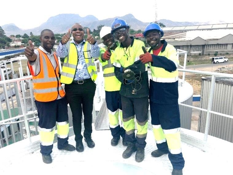 Five of the team in high-visibility PPE on site